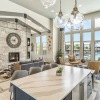 Clubroom with kitchen island, couches, and pool view