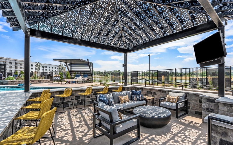 Pool deck and bar with seating and television